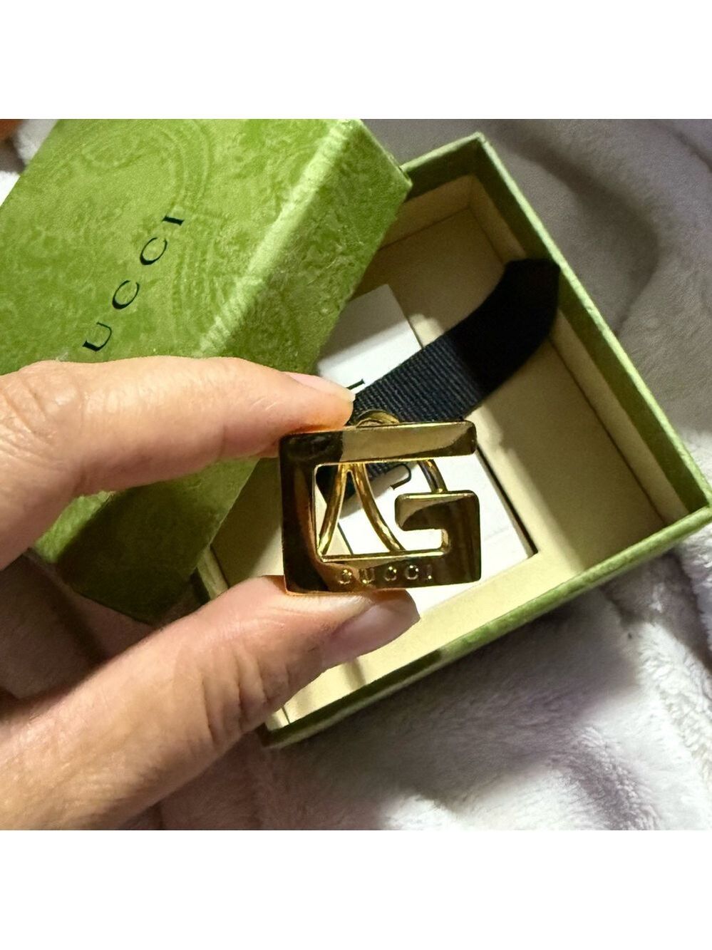 Gold metal Gucci scarf ring with logo at front